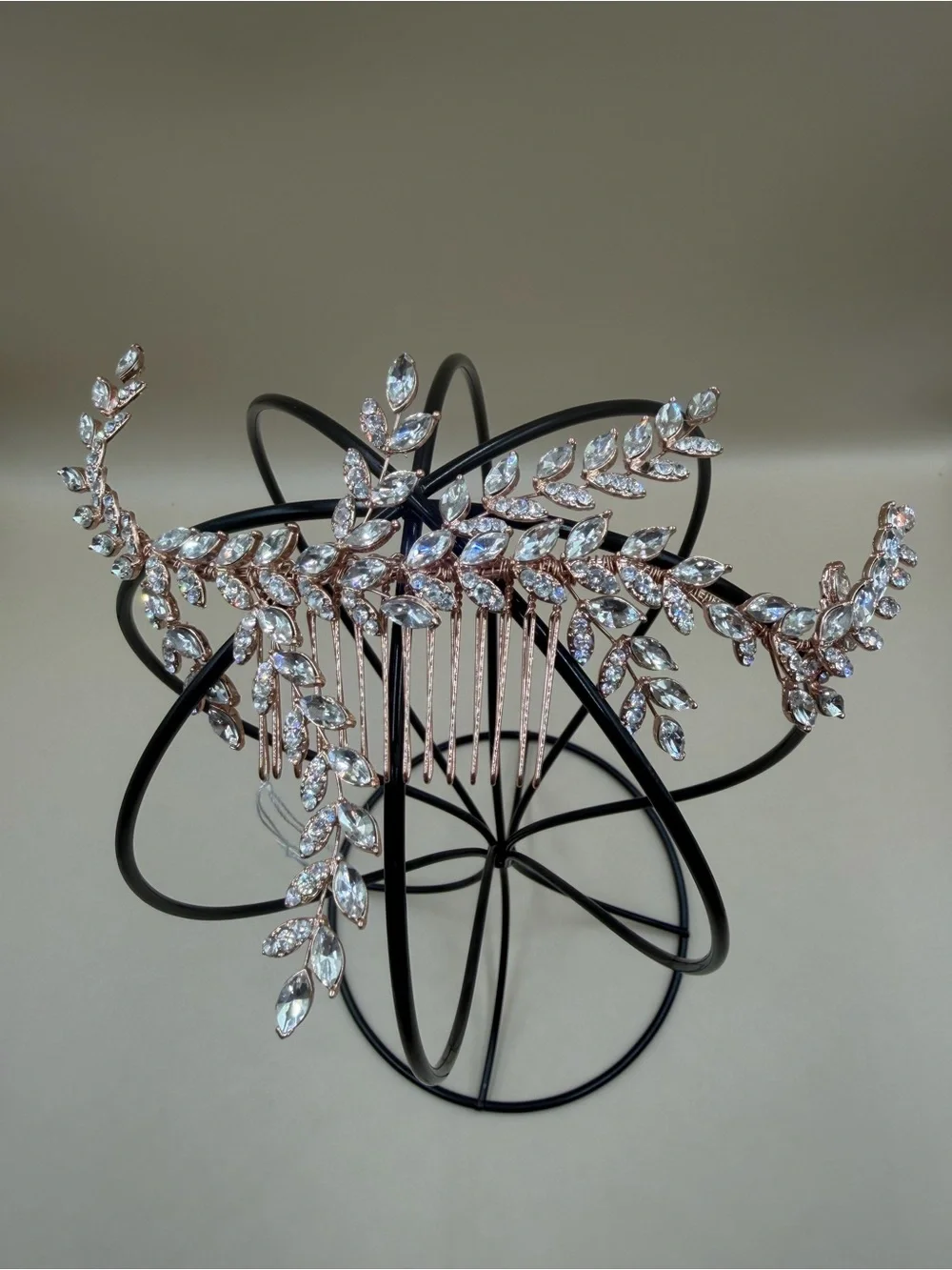 Elegant rose gold-tone bridal hair comb featuring a cascading leaf-and-vine desi